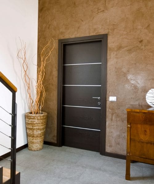 Dark modern internal door with steel inlays in a hallway