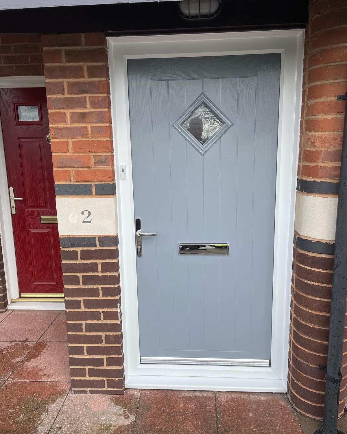 Grey composite front door with diamond glass fitted to a brick house in Newcastle