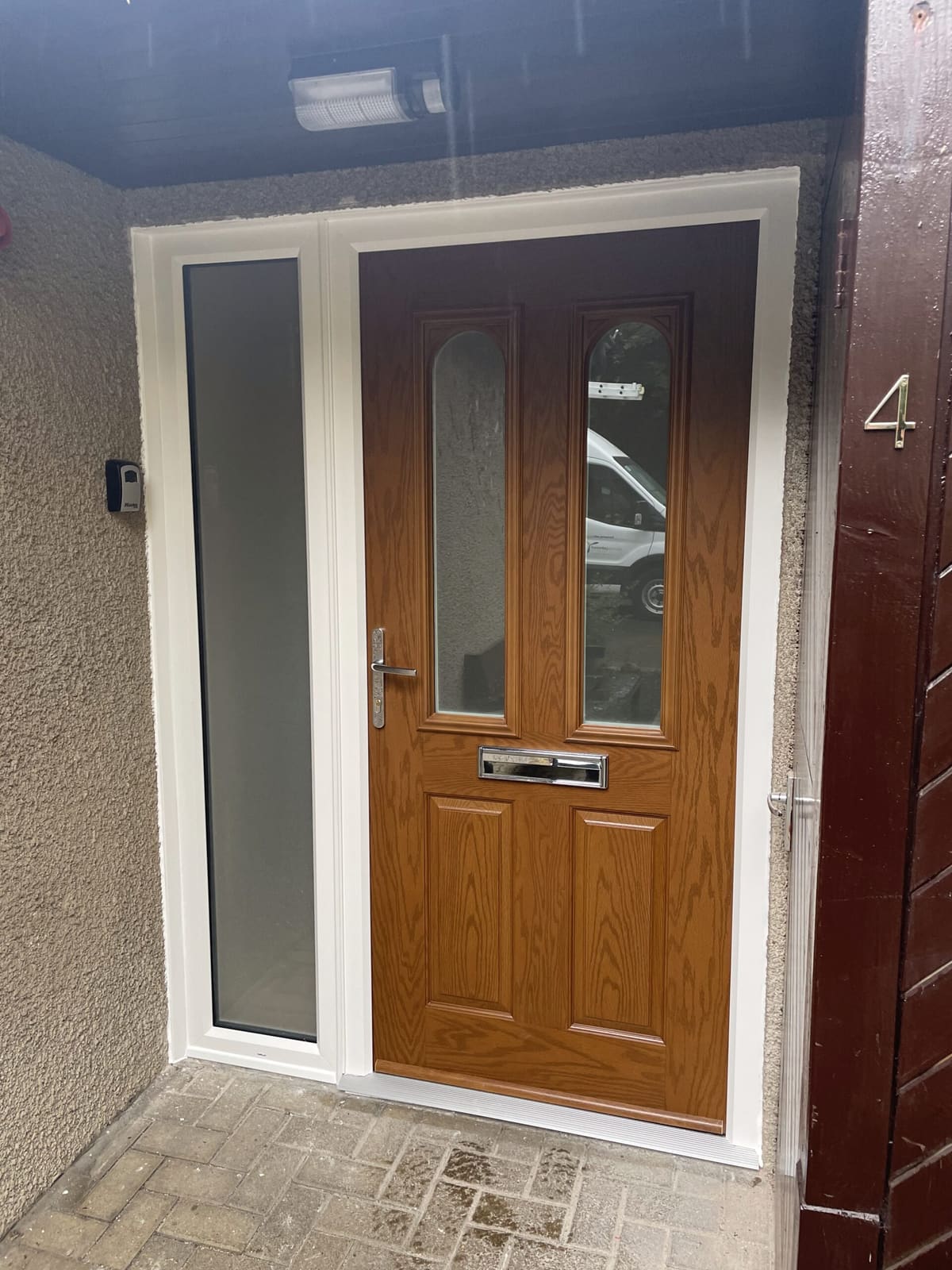 Oak-effect composite front door with glazed side panel fitted in Newcastle