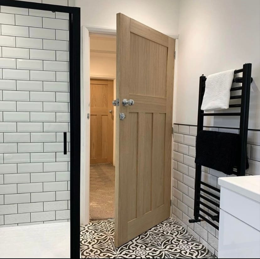 Oak panelled internal door fitted to a modern bathroom in Newcastle