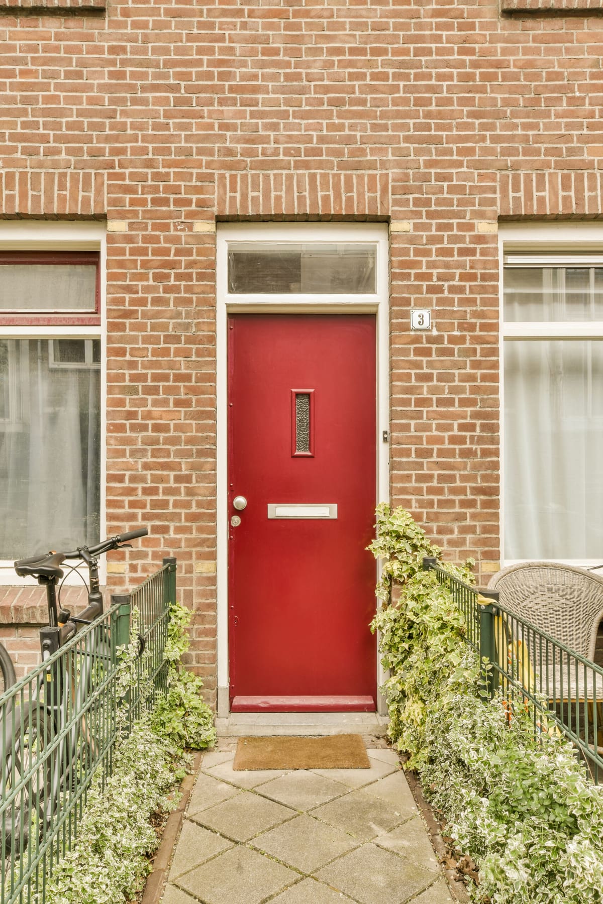 Red front door on a red brick terraced house