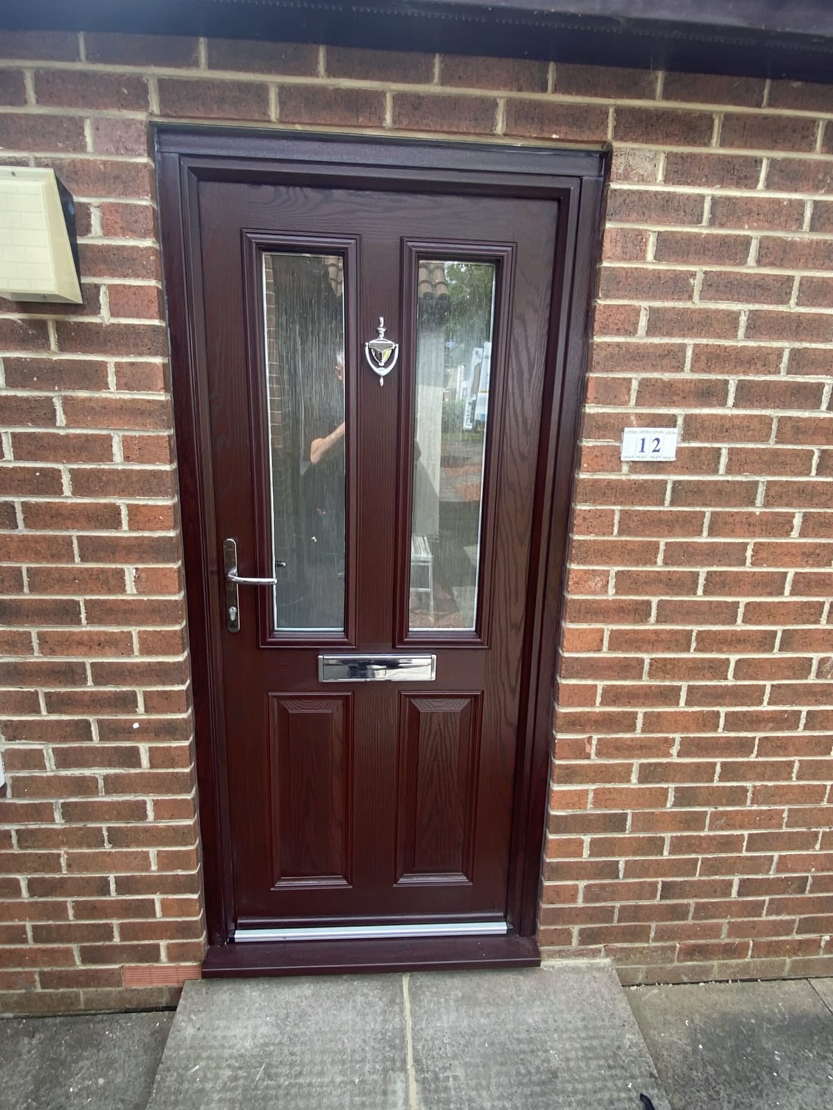 Rosewood composite front door with decorative glass fitted in Newcastle