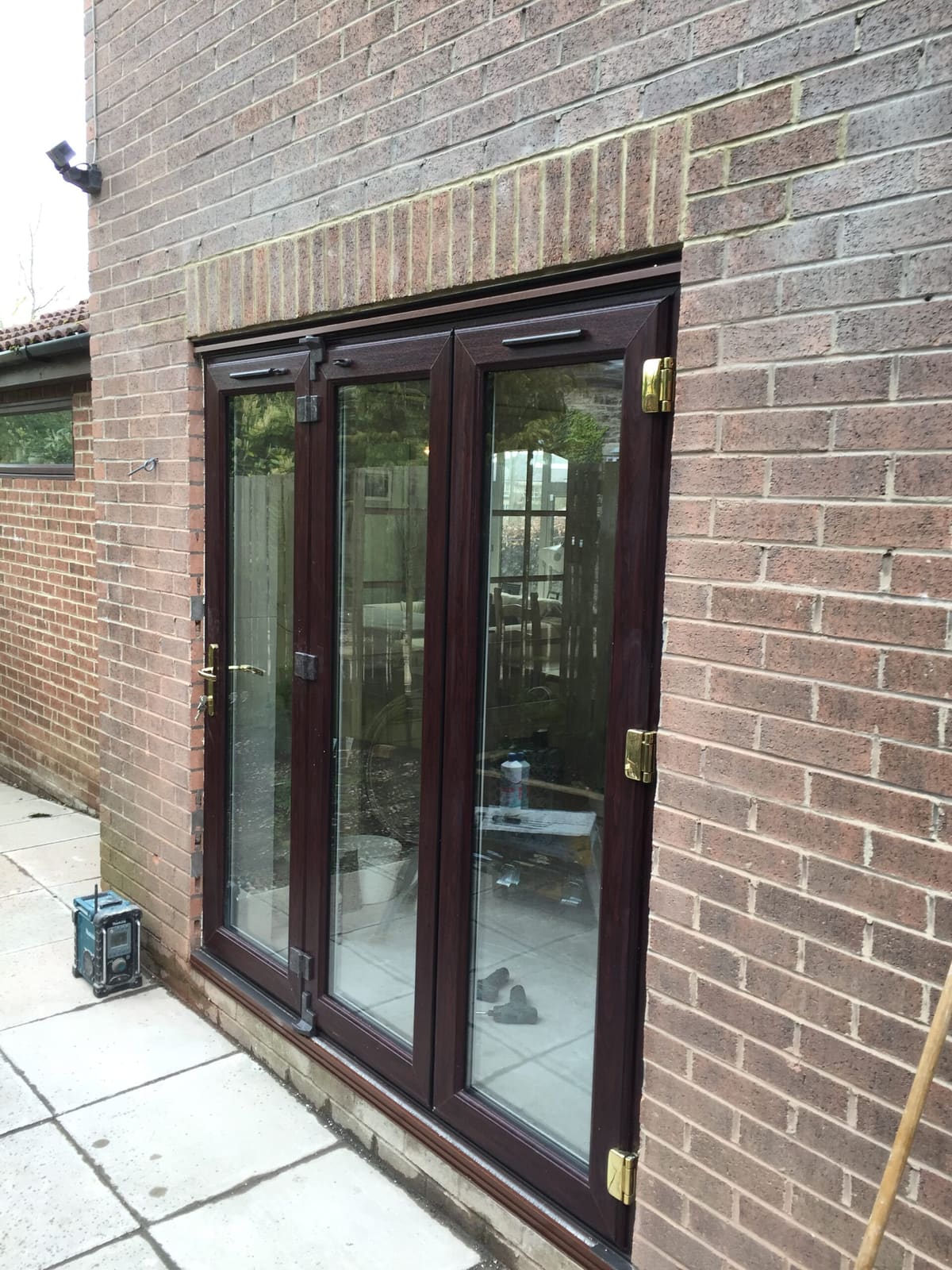 Rosewood uPVC glazed patio doors fitted to a brick house in Newcastle