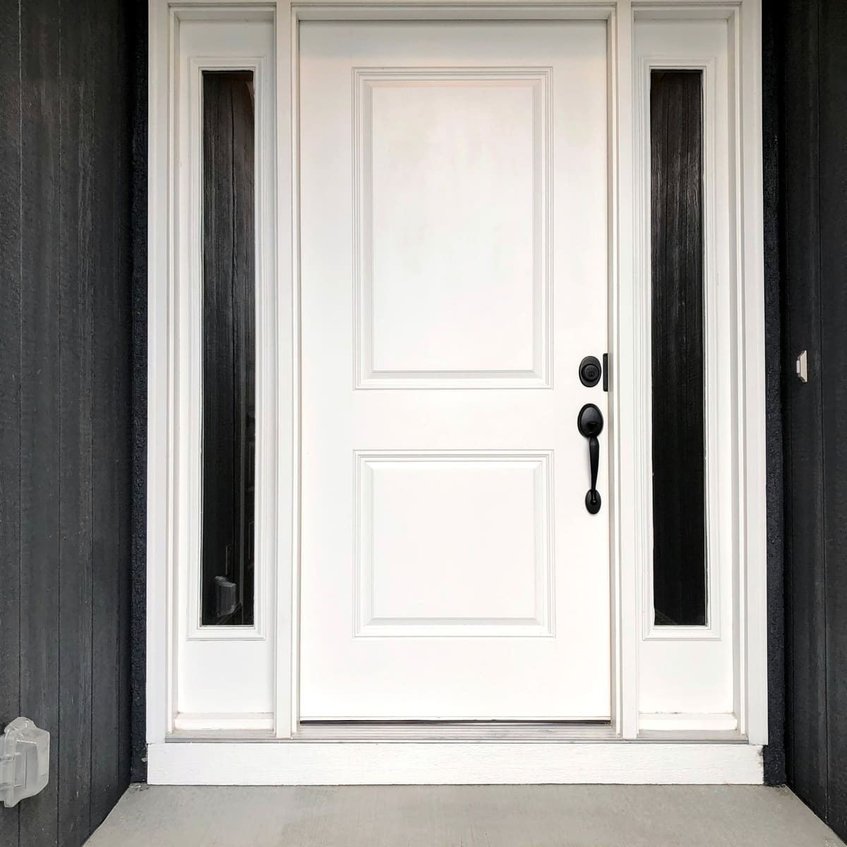 White panelled front door with tall glazed side panels