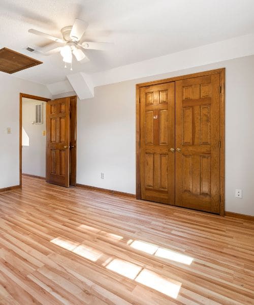 Wooden six-panel internal doors and double doors in a bright room